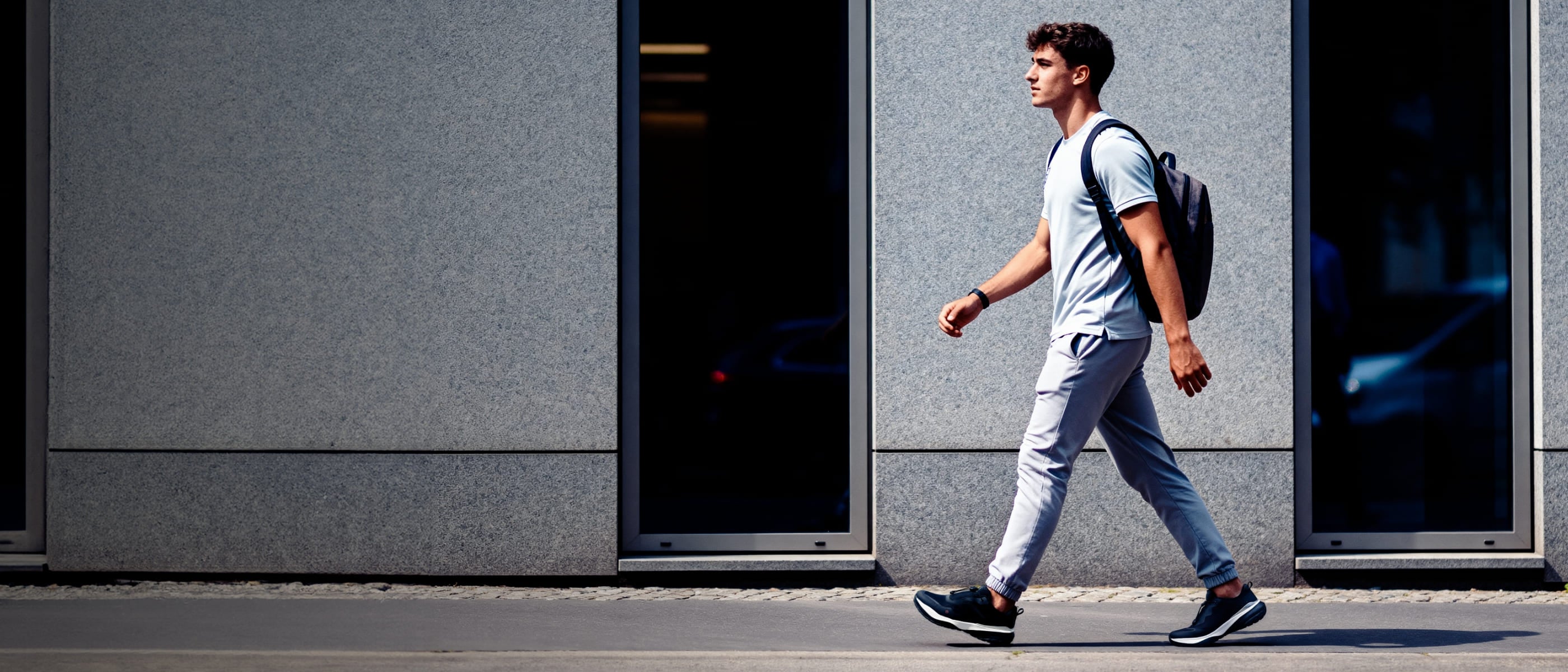 Man wearing lightweight S-16 Black slip-on walking shoes, perfect for stylish urban commuting.