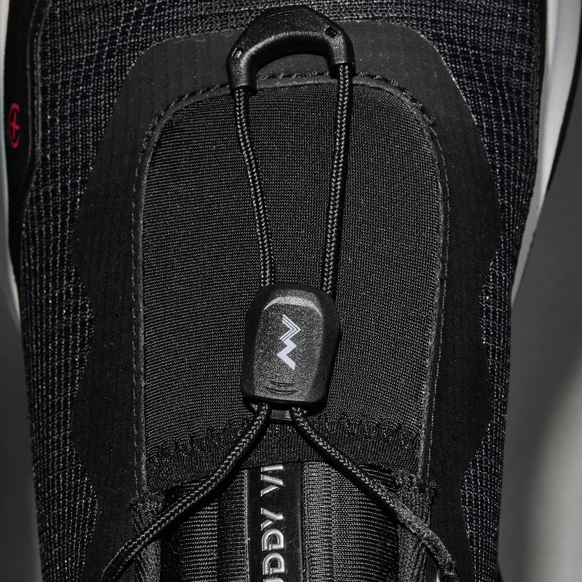 MUDDY VIBE S-16 Ridge Snow low-top hiking shoe with black and white accents, lace detail view on a soft shadow background.