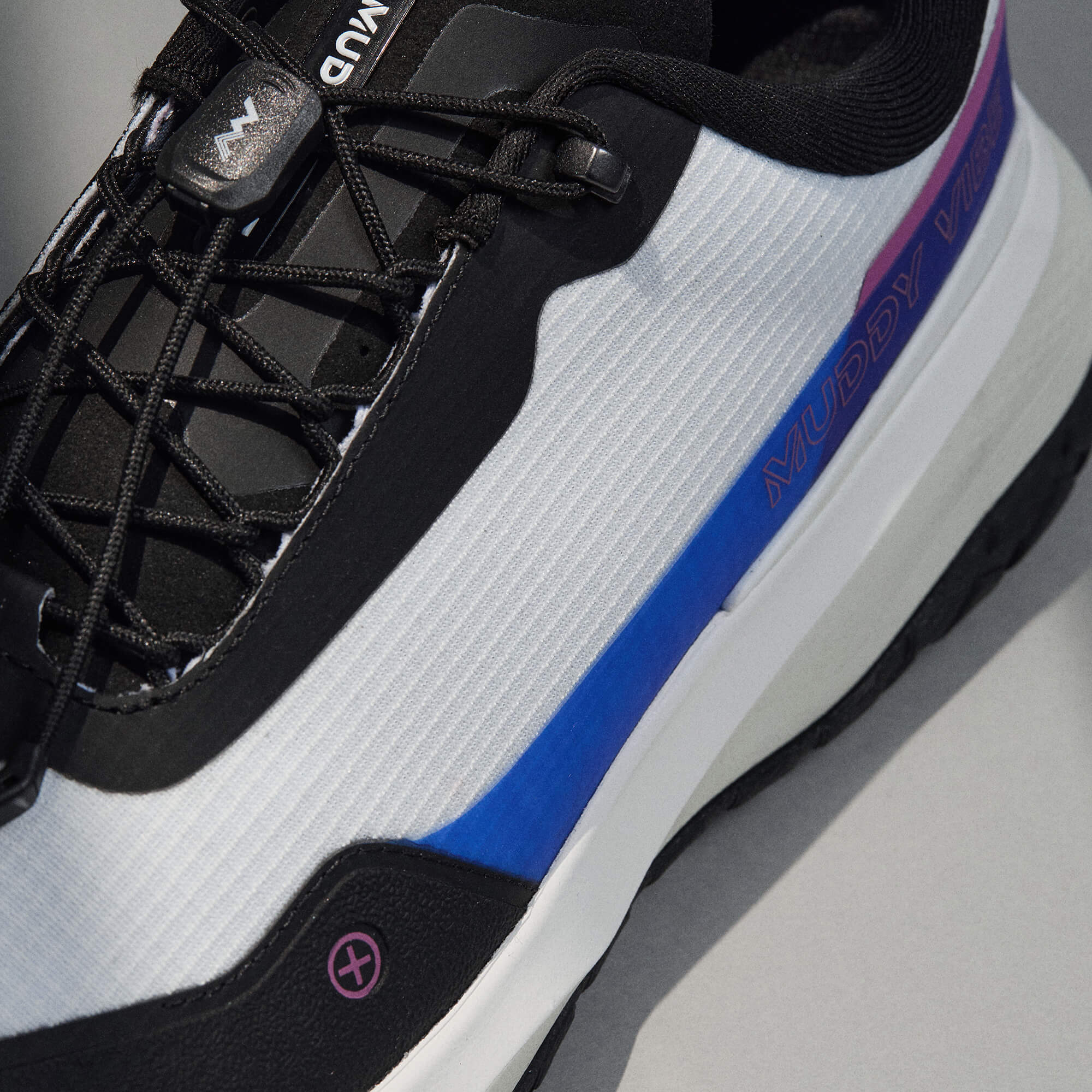 MUDDY VIBE Si-14 Aurora White low-top hiking shoe with black, blue, and purple accents, lace view on a soft shadow background.