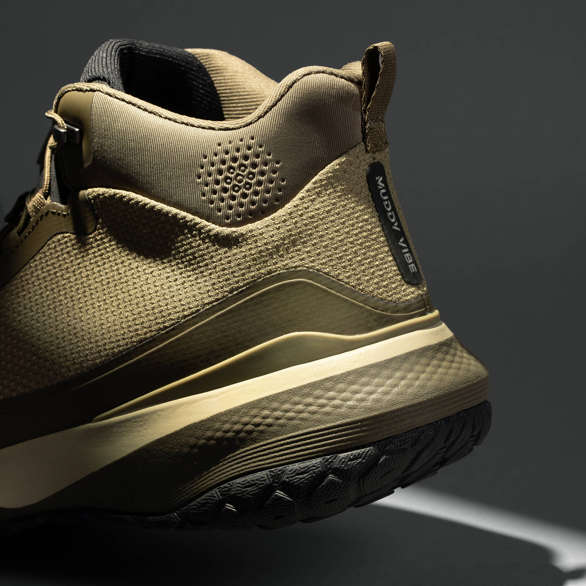 MUDDY VIBE Zn-30 mid-top Alpine Green hiking shoe with tonal green and beige accents, heel detail view on a soft shadow background.