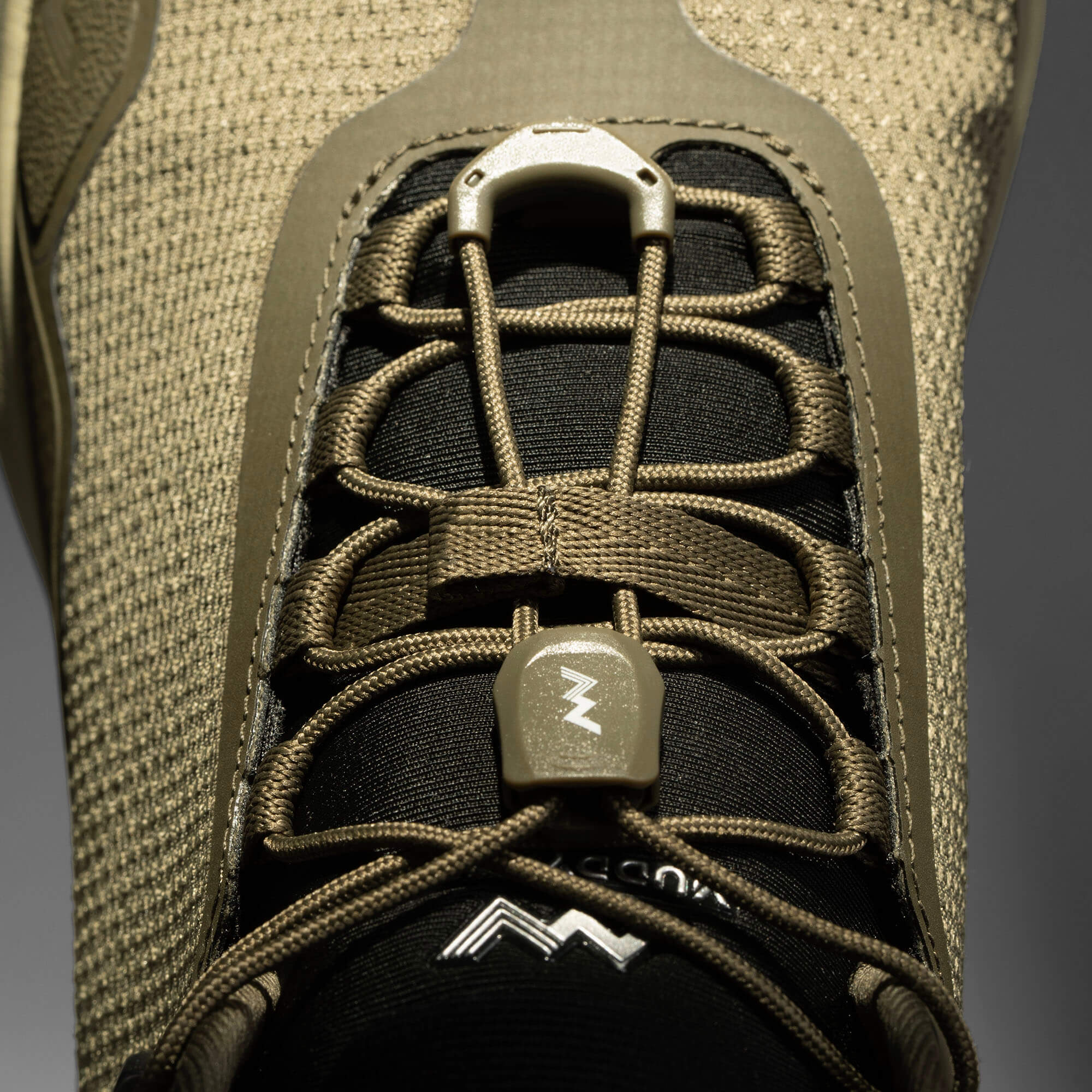 MUDDY VIBE Zn-30 mid-top Alpine Green hiking shoe with tonal green accents, lace detail view on a soft shadow background.