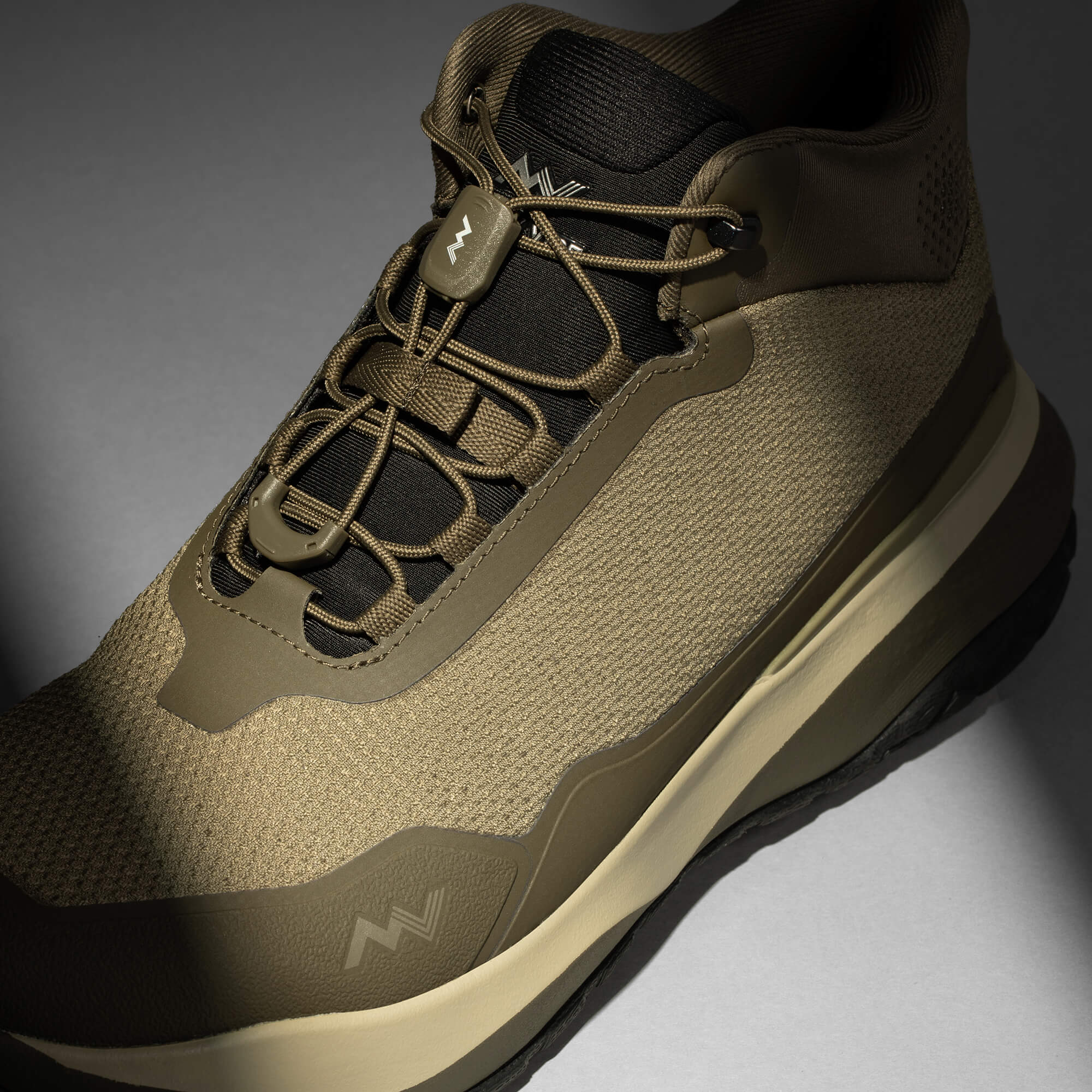 MUDDY VIBE Zn-30 mid-top Alpine Green hiking shoe with tonal green and beige accents, laces view on a soft shadow background.