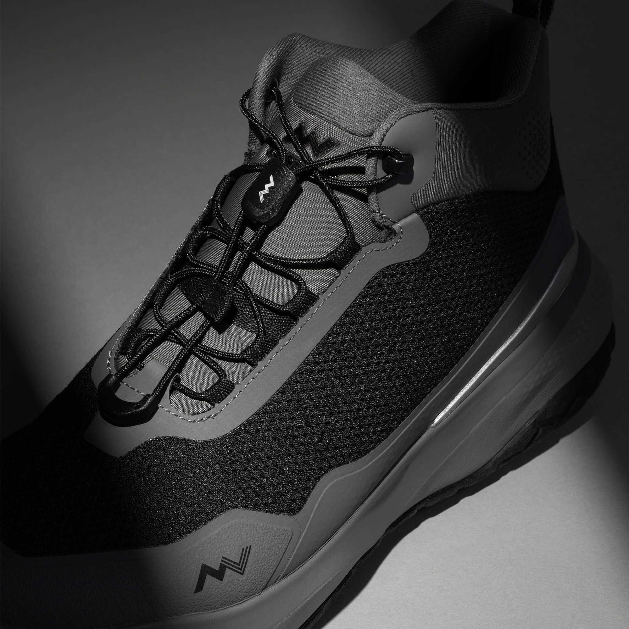 MUDDY VIBE Zn-30 Cliff Grey mid-top hiking shoe with black and white accents, laces view on a soft shadow background.