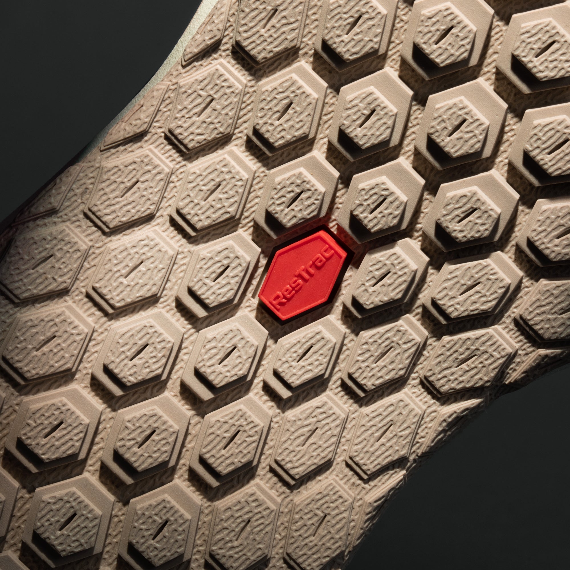 MUDDY VIBE Zn-30 Desert Sand mid-top hiking shoe with red accents, bottom view on a soft shadow background.