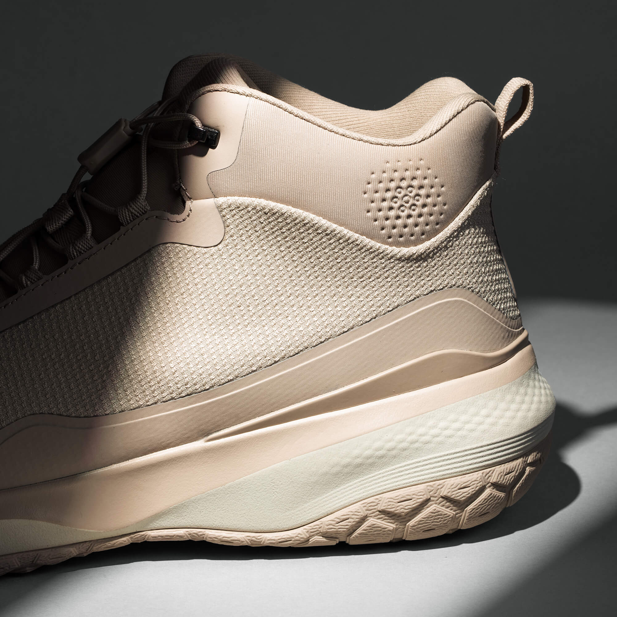 MUDDY VIBE Zn-30 Desert Sand mid-top hiking shoe with light beige and off-white accents, heel logo view on a soft shadow background.